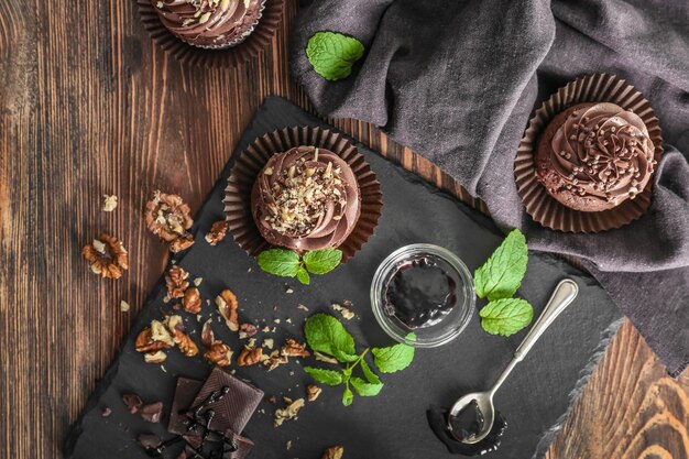 Photo composition with chocolate cupcakes on table