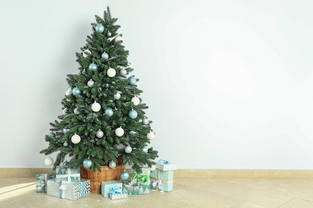 Composition with Christmas tree and gifts on background floor