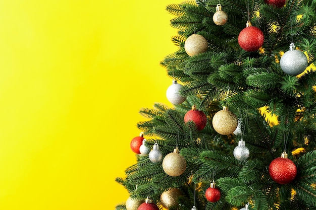 Composition with Christmas tree on yellow background