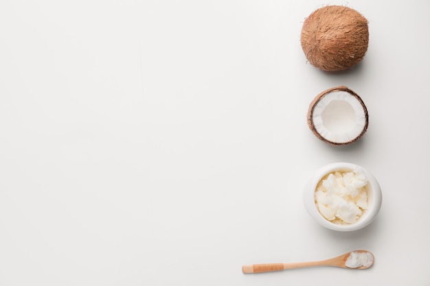 Photo composition with coconut and butter on light