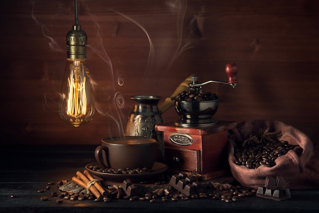 Composition with a coffee grinder and smoking coffee in the old style