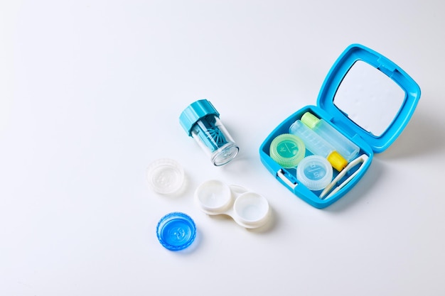 Composition with contact lenses and accessories on white background