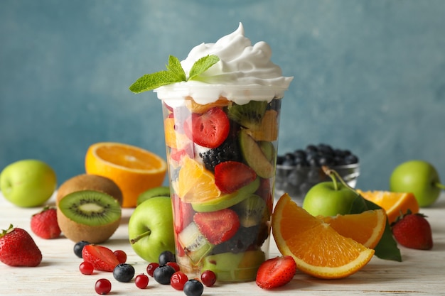 Composition with cup of fresh fruit salad