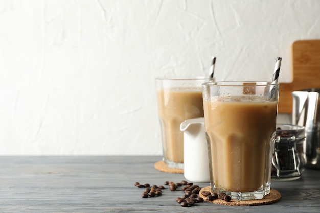 Composition with glasses of ice coffee on wooden background