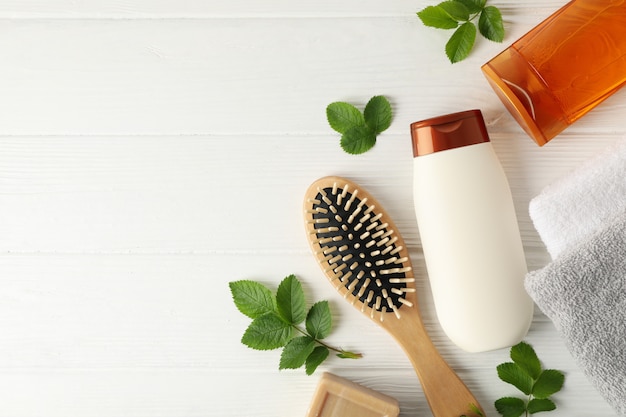 Composition with hair care products on wooden background, top view