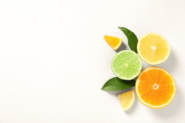 Composition with ripe lemon, orange and lime on white background