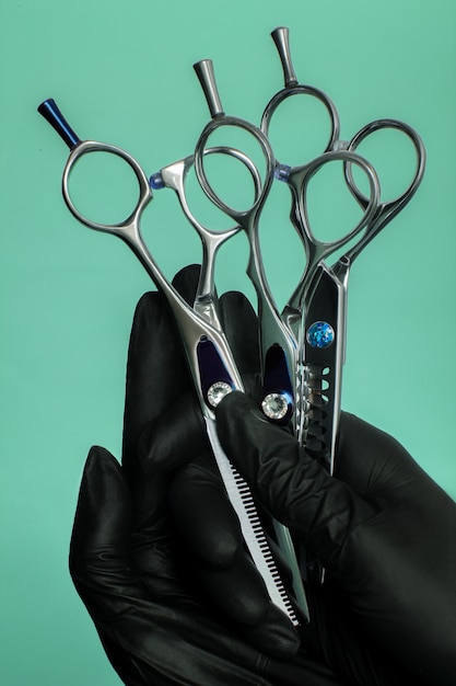 Composition with scissors and other hairdresser's accessories on green