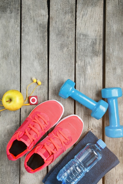 Composition with sport shoes on wooden background 