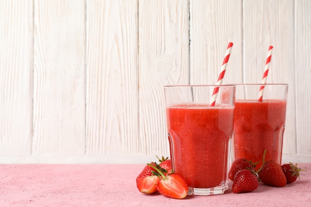 Composition with strawberry cocktails on pink table. Summer drink