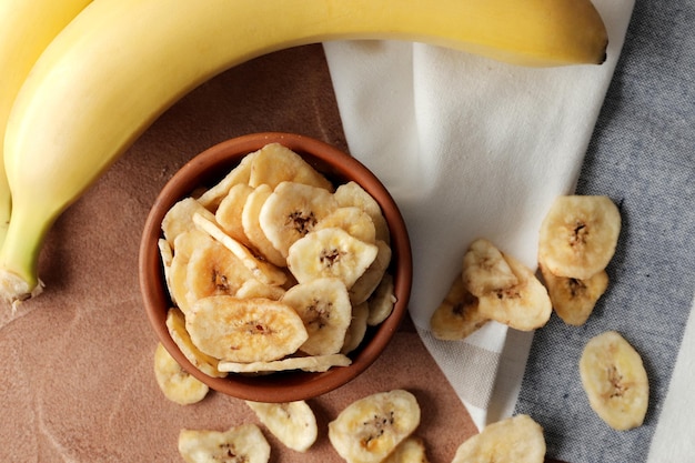 Photo composition with sweet dried banana slices, fresh bananas. top view with space for text. dried fruit as healthy snack. healthy breakfast