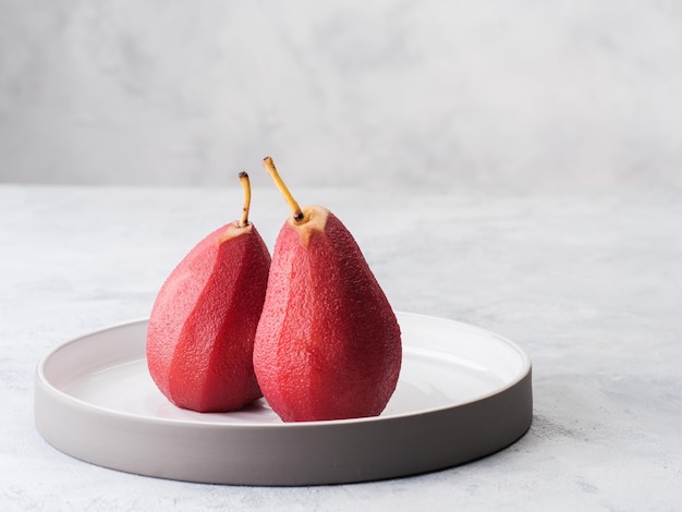 Composition with sweet poached pears on light background