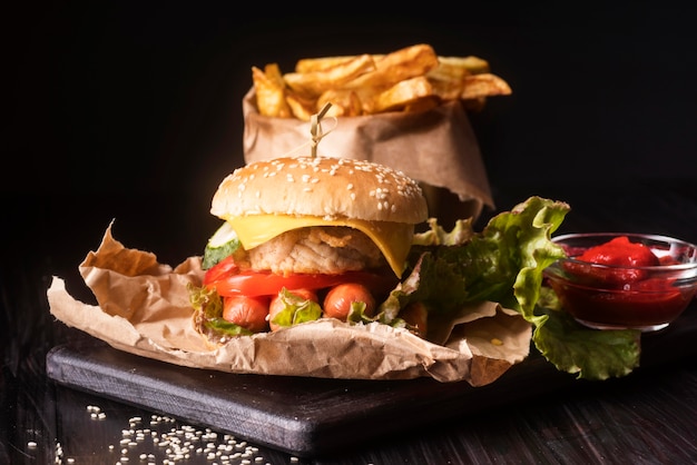 Composition with tasty hamburger and fries