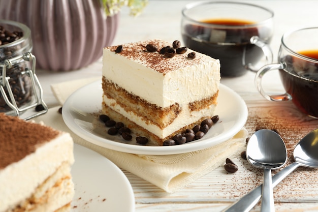 Composition with tasty tiramisu on white wooden background. Delicious dessert