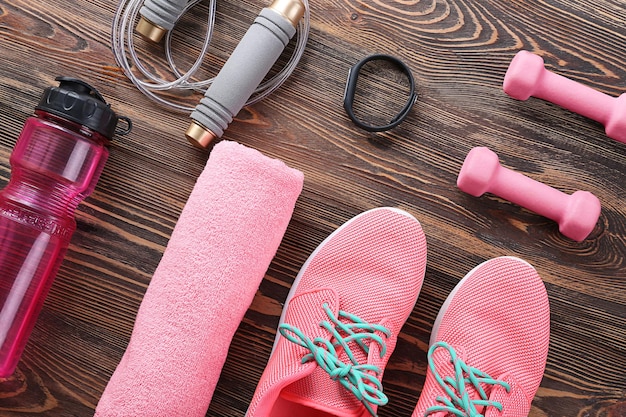 Composition with towel and sport equipment on wooden background