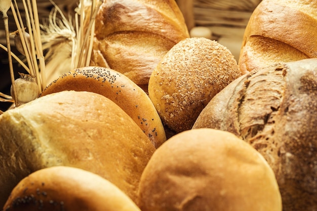 Composition with variety of baking products and buns inside basket Bakery and grocery concept