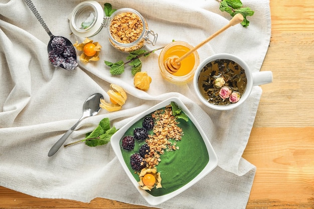 Composition with yummy spirulina smoothie on wooden table Healthy vegan food concept