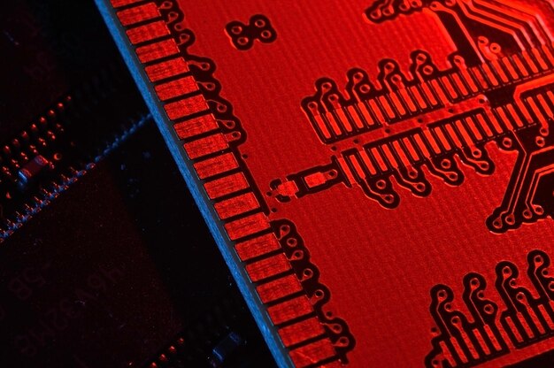 Photo computer cpu processor chip on circuit board motherboard background closeup with redblue lighting