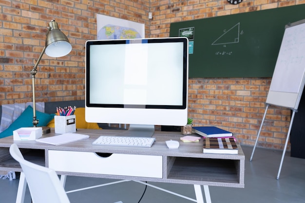 Computer on desk and equipment in a teacher's online classroom