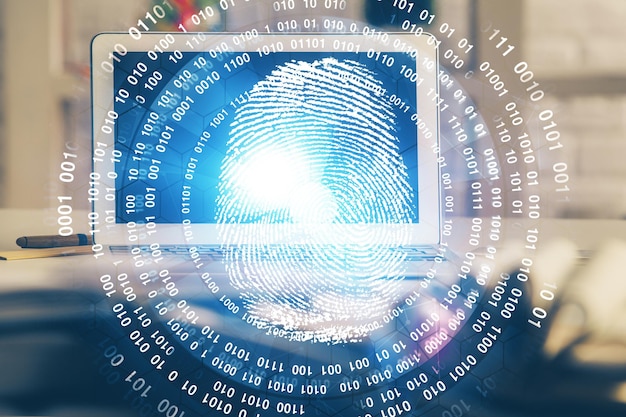 Photo computer on desktop in office with finger print drawing double exposure concept of business data security