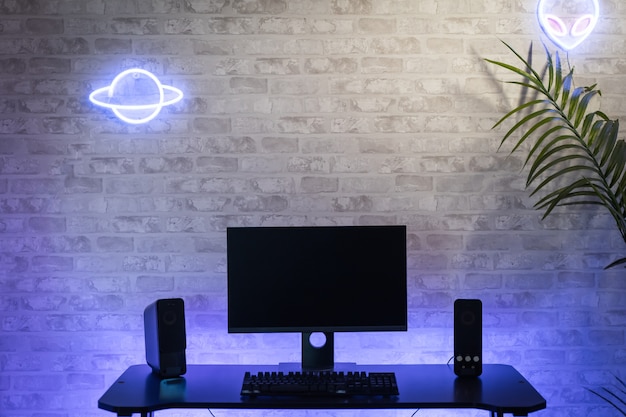 Computer gamer workspace with black screen monitor with neons and colorful lights Gamer Rig