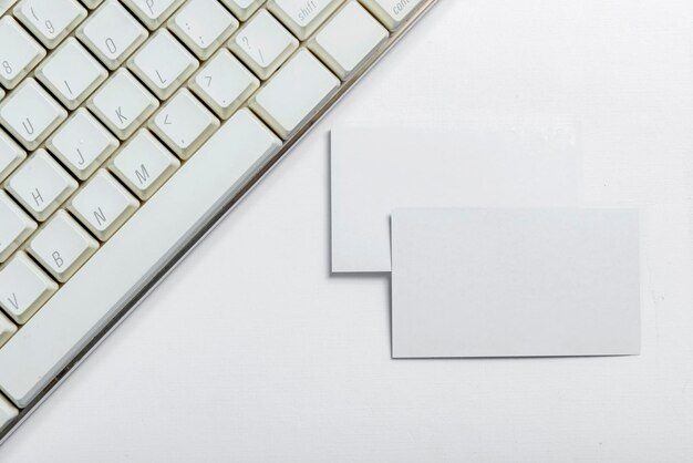 Computer keyboard and empty white paper on the desk Empty white paper for copy space