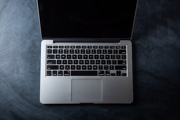 Computer keyboard and tea cup on the table