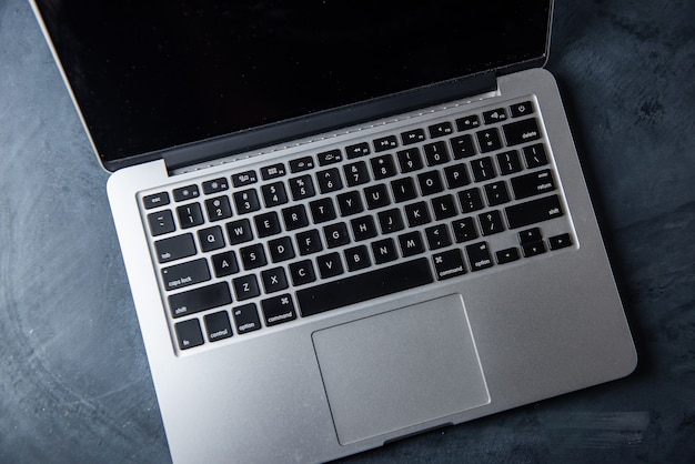 Computer keyboard and tea cup on the table