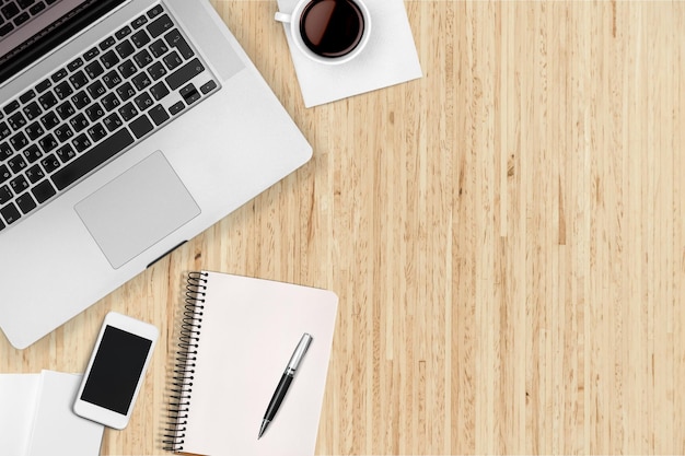 Computer keyboard at workplace and cup isolated on  background