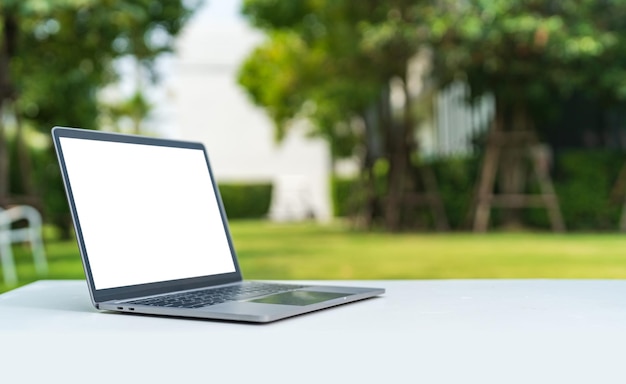 Computer laptop with blank back screen on the table in the garden