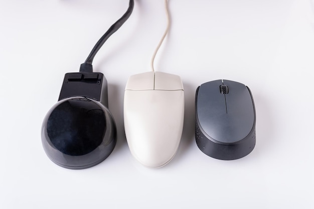 Computer mice of different generations on a white background