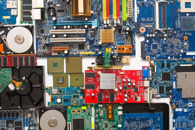 Computer microcircuits, processor chips and hard drives disassembled closeup. Electronic parts of computer background, top view