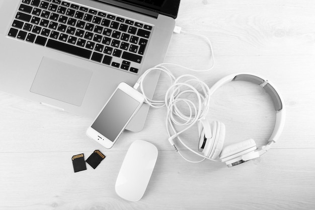 Photo computer peripherals and laptop accessories on white wooden background