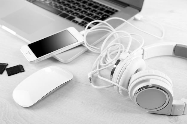 Photo computer peripherals and laptop accessories on white wooden background