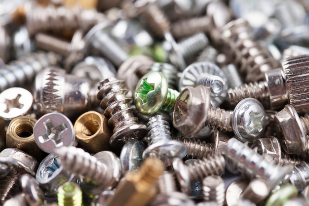 Computer screws background, hardware, bolts, nuts, selective focus