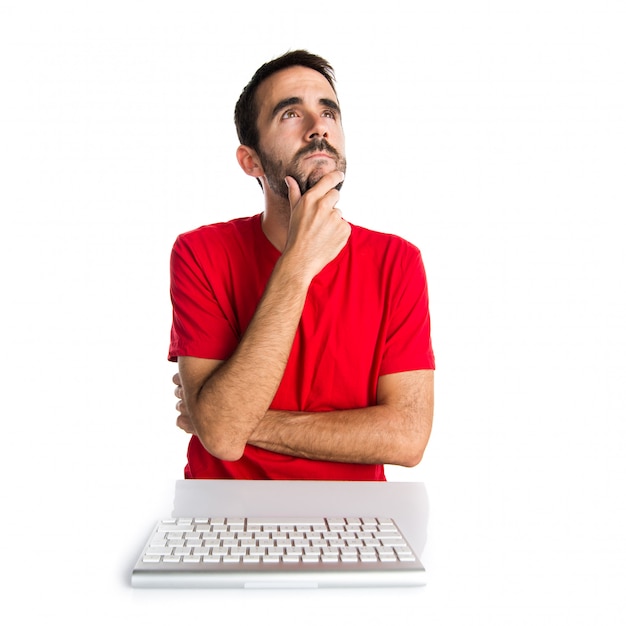 Computer technician working with his keyboard thinking