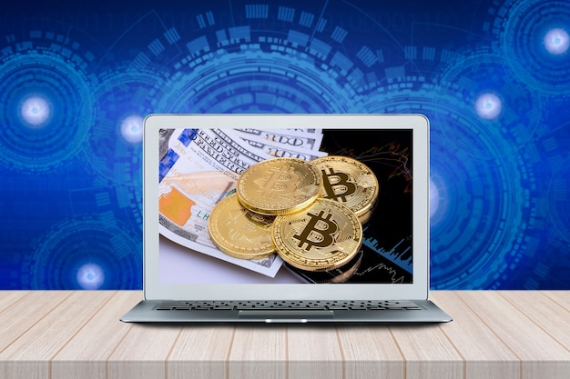 Computer with Bitcoins on investment money moving graph on screen