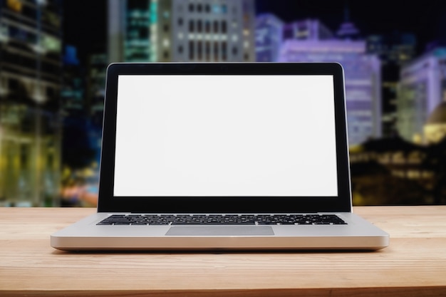 Computer with white screen on table with blur background. Technology concept.