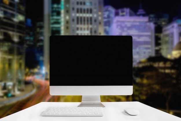 Computer with white screen on table with blur background. Technology concept.