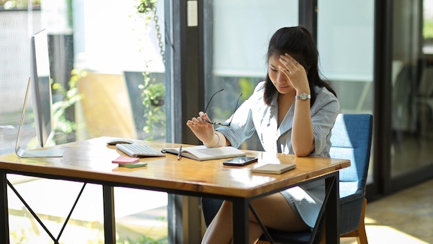 Concentrated asian businesswoman reading a textbook or financial investment book