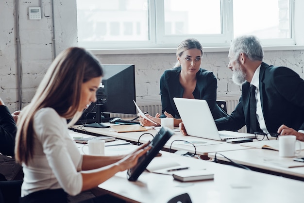 Concentrated colleagues having staff meeting while working together in the modern office