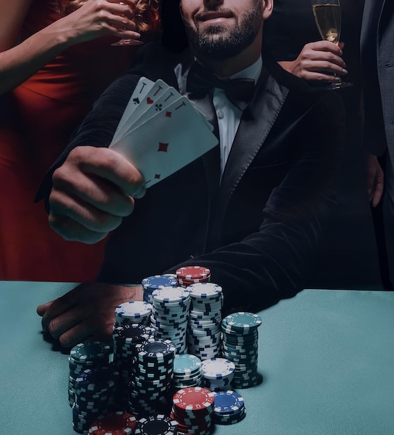 Concentrated men and women playing poker in casino