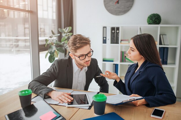 Concentrated young man sit together with woman