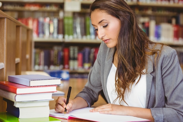 Concentrating brunette student doing her assignment