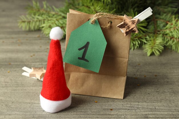 Concept of Advent calendar gift on gray wooden background.