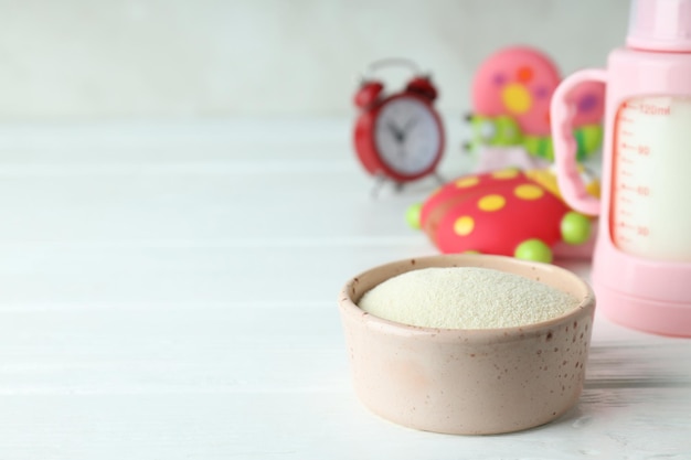 Concept of baby food with ÃÂÃÂowdered milk on white wooden table