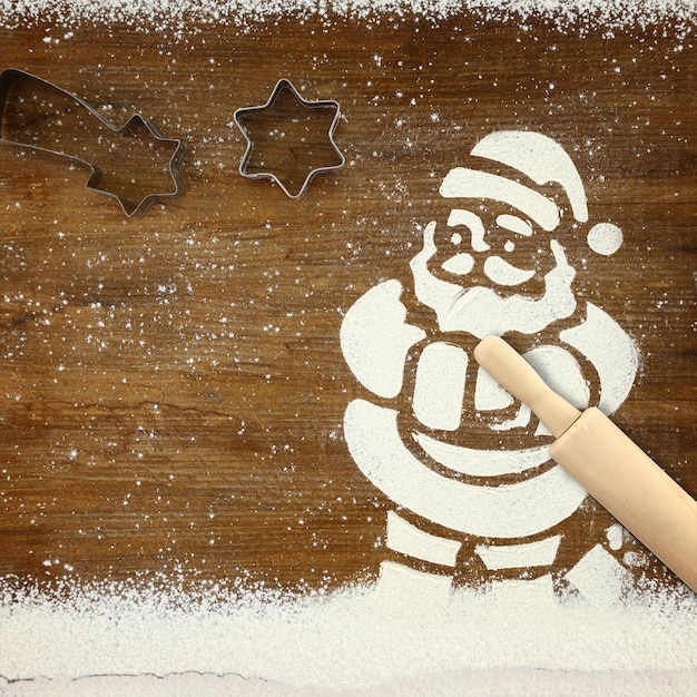 Concept for baking with Santa Claus and snow made of flour