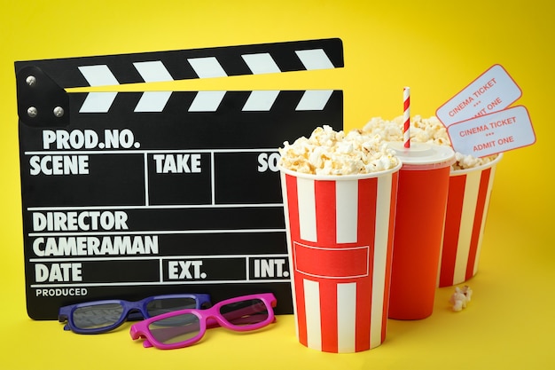 Concept of cinema accessories on yellow background.