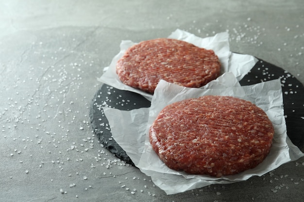 Concept of cooking burger on gray textured table