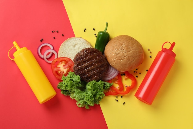 Concept of cooking burger on two tone background