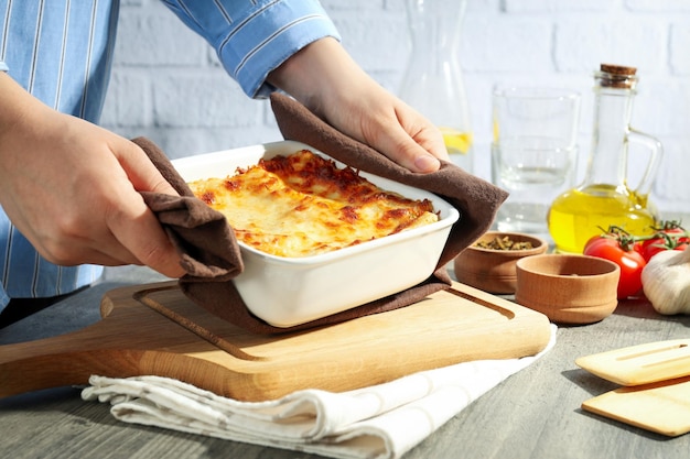 Concept of cooking composition of cooking Lasagna on gray textured table